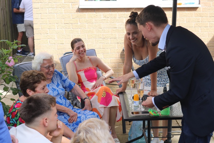 Ryan Beck performing magic at a table