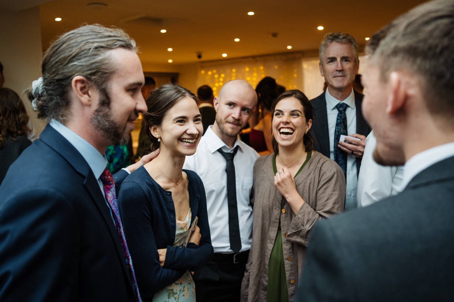 Group of wedding guests reacting to magic