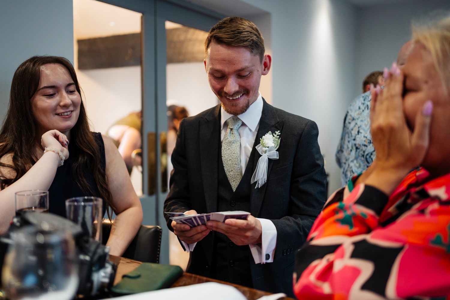 Ryan Beck performing magic at a table