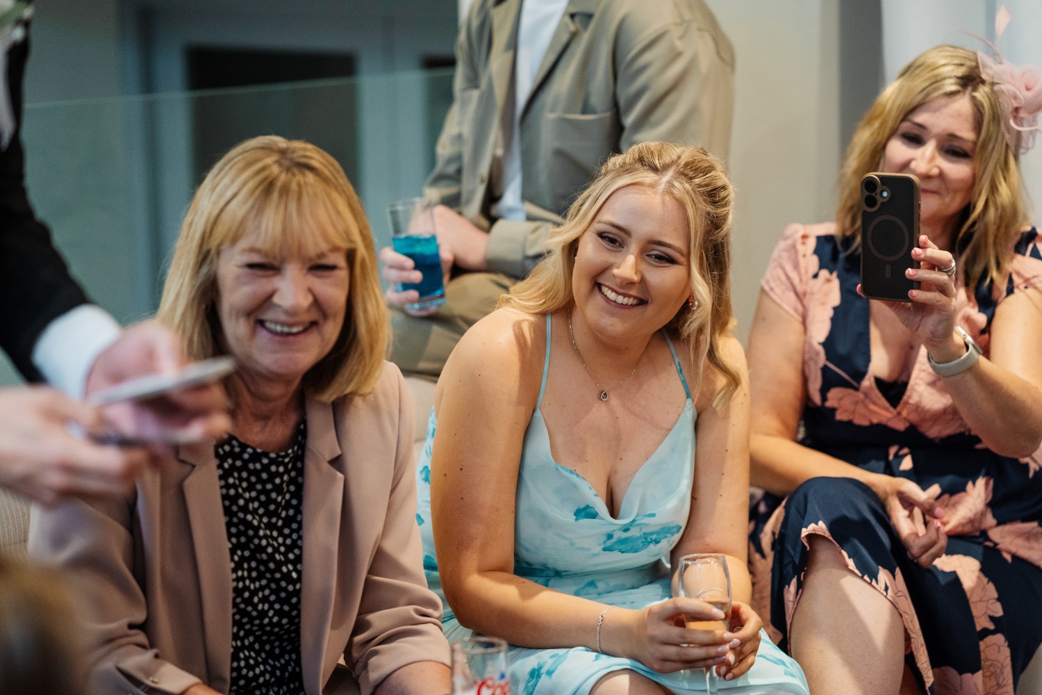 Guests laughing during a magic performance